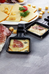Delicious traditional Swiss melted raclette cheese on diced boiled or baked potato.