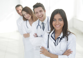 Fototapeta premium female doctor with group of happy successful colleagues
