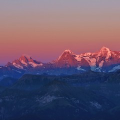 Fototapeta na wymiar Mountains Schreckhorn, Eiger and Monch at sunset. View from Mount Niesen. Switzerland.