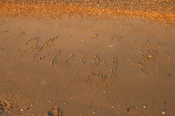 happy written on sand