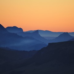 Fototapeta na wymiar Outlines of Mount Wiriehore and other mountains in the Bernese Oberland. Sunset seen from Mount Niesen. 