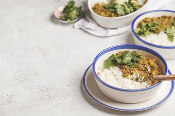 Lentil curry with rice, Indian cuisine, tarka dal, white background. Vegan food.