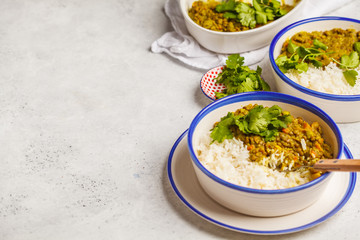 Lentil curry with rice, Indian cuisine, tarka dal, white background. Vegan food.