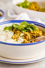 Lentil curry with rice, Indian cuisine, tarka dal, white background. Vegan food.