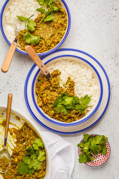 Lentil curry with rice, Indian cuisine, tarka dal, white background, top view. Vegan food.