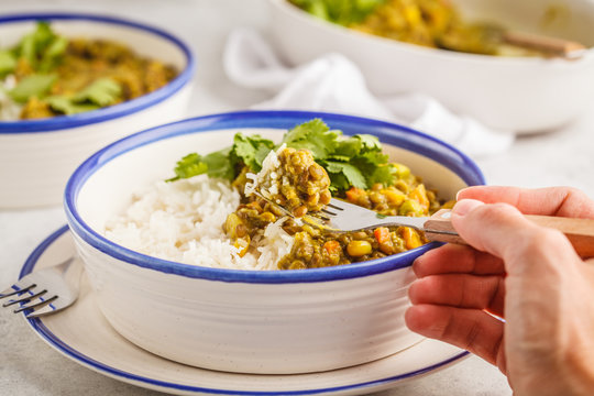Lentil curry with rice, Indian cuisine, tarka dal, white background. Vegan food.