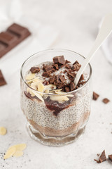 Chia pudding with chocolate, almonds and berry jam. Raw vegan dessert.