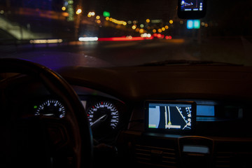 Navigator installed in the car. The car is in the night city