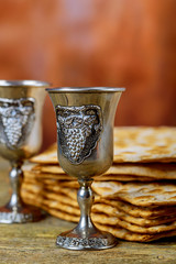Passover background. wine and matzoh jewish holiday bread over wooden board.