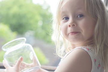 the little merry girl lets the moth out of the jar