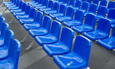 Plastic hire chairs in a row blue color