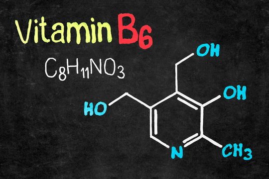 Handwritten chalk chemical formula of Vitamin B6 on school blackboard.