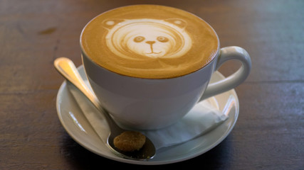 Cup of cappuccino with panda face on foam