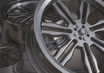 Silvery car wheels on a gray