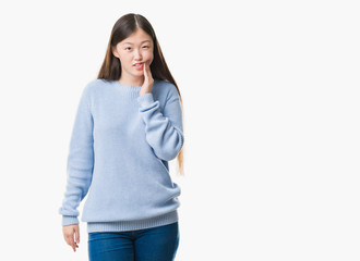 Young Chinese woman over isolated background touching mouth with hand with painful expression because of toothache or dental illness on teeth. Dentist concept.