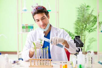 Young biotechnology scientist chemist working in lab