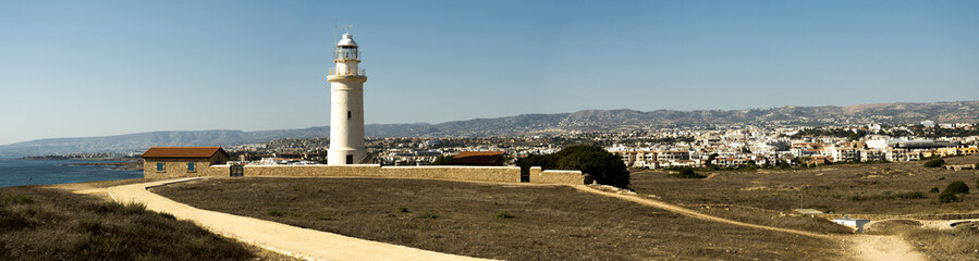 Fototapeta na wymiar A scenic panorama of a Paphos lighthouse, city, mountains and Mediterranean sea, Cyprus