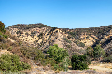 Fototapeta na wymiar Steep, dry hillsides on hot summer day in Southern California mountains
