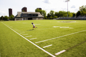 boy running on a football field