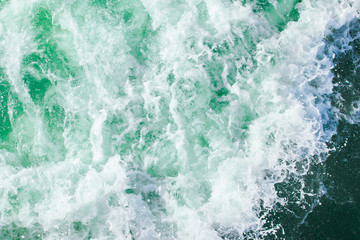 Fototapeta premium surface of turquoise ocean water with white foam, background, texture