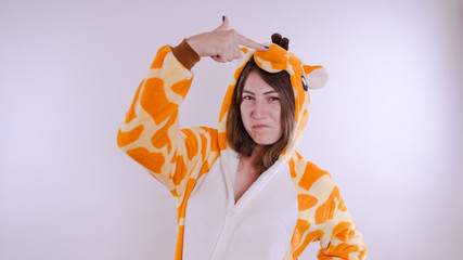 Funny girl in kigurumi pajamas. Emotional portrait of a student. costume presentation of children's...
