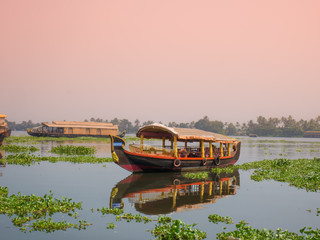 A houseboat sailing in kerala backwaters during sunset.