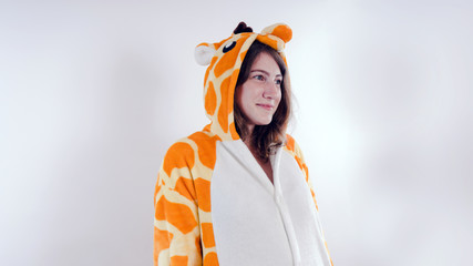 Funny girl in kigurumi pajamas. Emotional portrait of a student. costume presentation of children's...