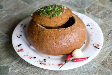 Soup on bread. Russian cuisine. Served chili and garlic.