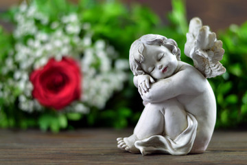 Condolence card with sleeping angel and flowers 