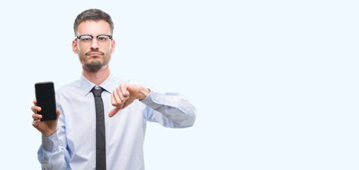 Young business adult man talking on the phone with angry face, negative sign showing dislike with thumbs down, rejection concept