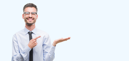 Young business man very happy pointing with hand and finger