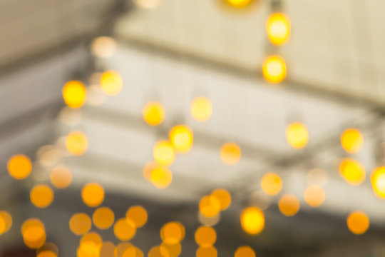 Blurred Shapes of Incandescent Electric Lamps Placed Under Roof Indoors