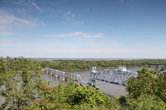 Train bridge over river from elevated view