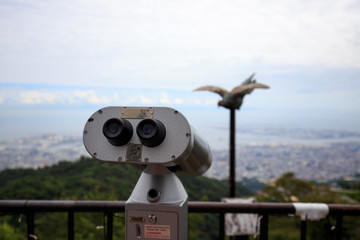 Coin operated viewing scope with fake pole mounted bird on top of Mt. Rokko in Hyogo, Japan