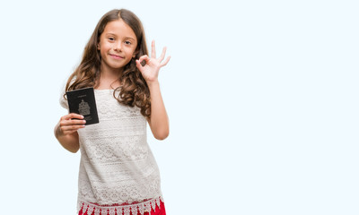 Brunette hispanic girl holding passport of Canada doing ok sign with fingers, excellent symbol
