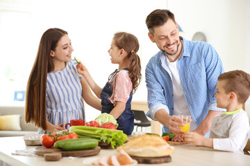 Obraz na płótnie Canvas Happy family with children having breakfast in kitchen