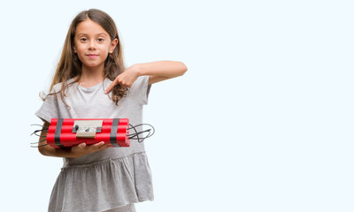 Brunette hispanic girl holding a bomb with surprise face pointing finger to himself