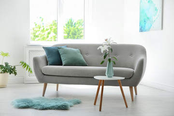 Stylish living room interior with sofa and mint decor elements