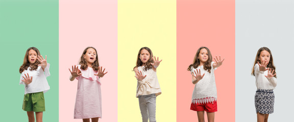 Collage of brunette hispanic girl wearing different outfits afraid and terrified with fear expression stop gesture with hands, shouting in shock. Panic concept.