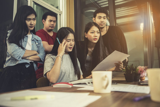 asian younger freelance team concentrate on working project in computer monitor