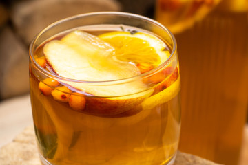 hot autumn drink cider from apples with lemon, cinnamon, sea buckthorn and anise stars