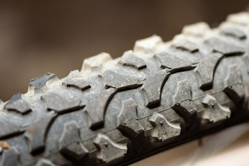 Closeup macro image of a bikes rear wheel with rubber tread detail in natural sunlight and a copyspace area for cycling adventure mountain bike ideas