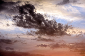Dramatic stormy clouds with abeautiful amazing colors and a sunset with no landscape in this cloudscape