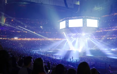 Keuken achterwand Stadion Concert stage with shining lights and crowd at a performance. Rock music event at a stadium with colorful spotlights and projectors.  © CaptureAndCompose