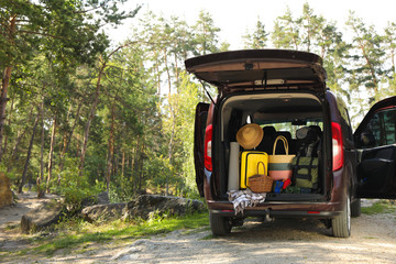 Van with camping equipment in trunk outdoors