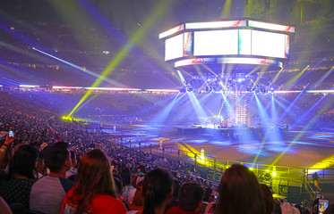 Concert stage with shining lights and crowd at a performance. Rock music event at a stadium with...