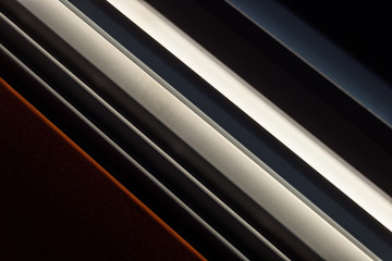 Diagonal lights and slits creates a dark abstract of form and repetition