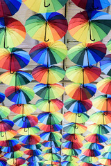 Rows of multicolored umbrellas creates a surreal abstract background