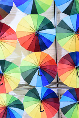 Rows of multicolored umbrellas creates a surreal abstract background