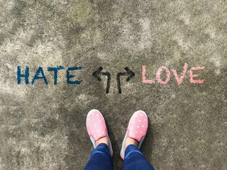 Hate or Love arrow and pink slipper  shoe on concrete background